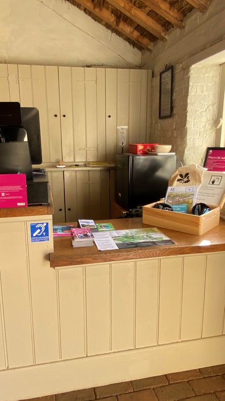 The lower height visitor welcome desk in the Estate Barn at Blickling Estate